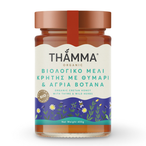 Jar of Thamma organic honey with a white label on a white background